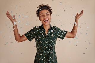 Positive african american woman smiling confetti studio shot goodhumoured black girl expressing happiness